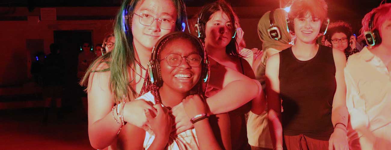 Smiling teens at silent disco evening activity