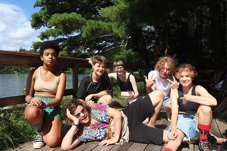 Group of funky teens posing for a photo at camp.